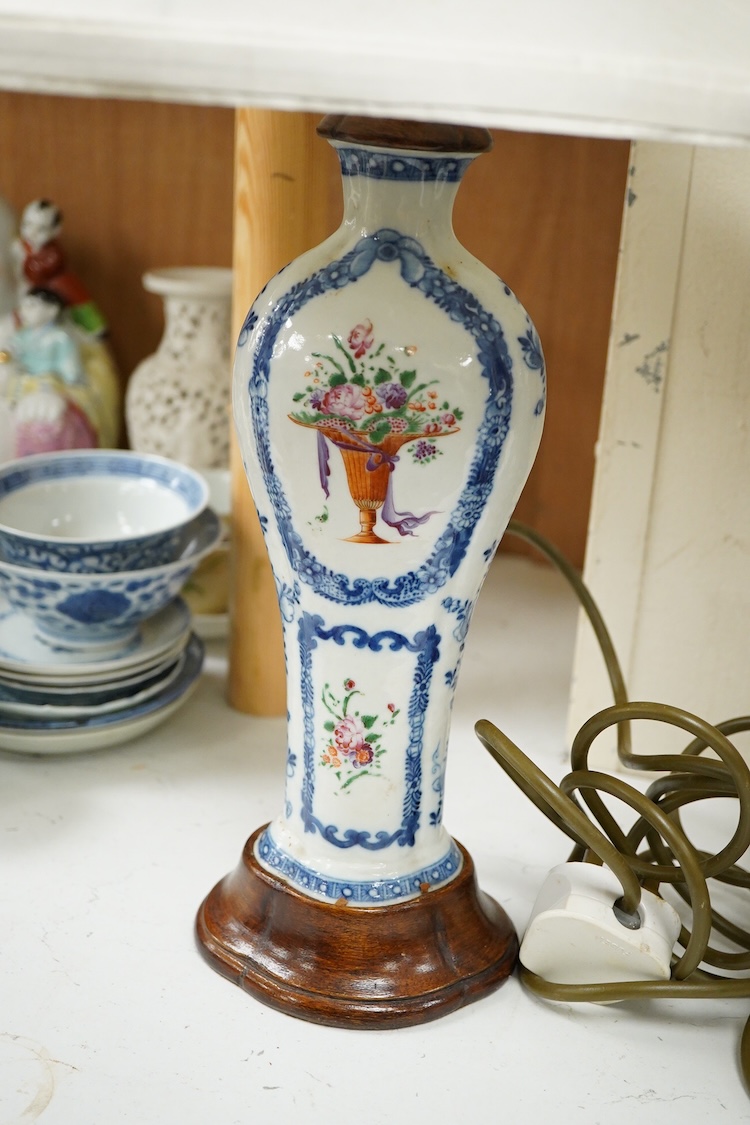 Two Chinese famille rose vases from a garniture, Qianlong period (1736-95), mounted as table lamps with shades, raised on shaped wood bases, overall 62cm high